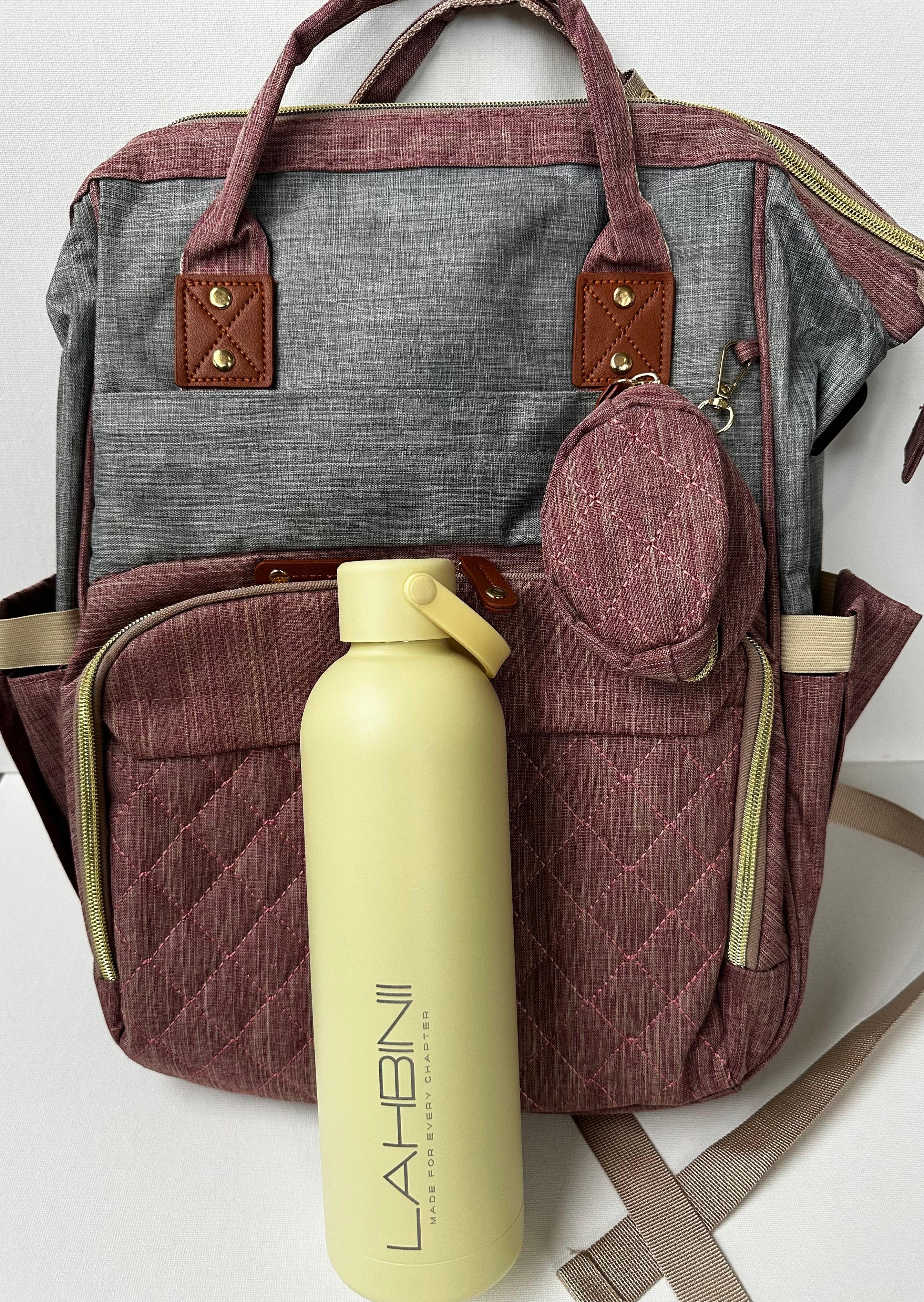 Lahbinii multipurpose diaper backpack with organized compartments and a matching bottle for parents on the go.